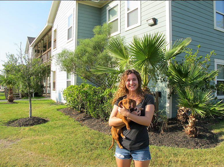 UAG resident holding a cat outside the apartment community