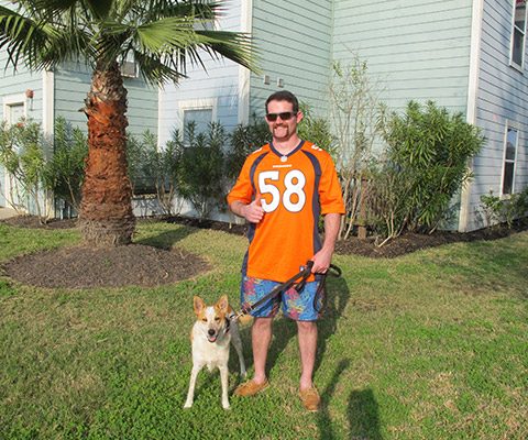 UAG resident standing outside with a dog