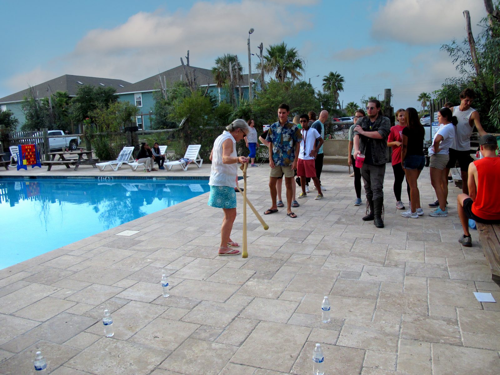 Residents enjoying a community event beside the pool