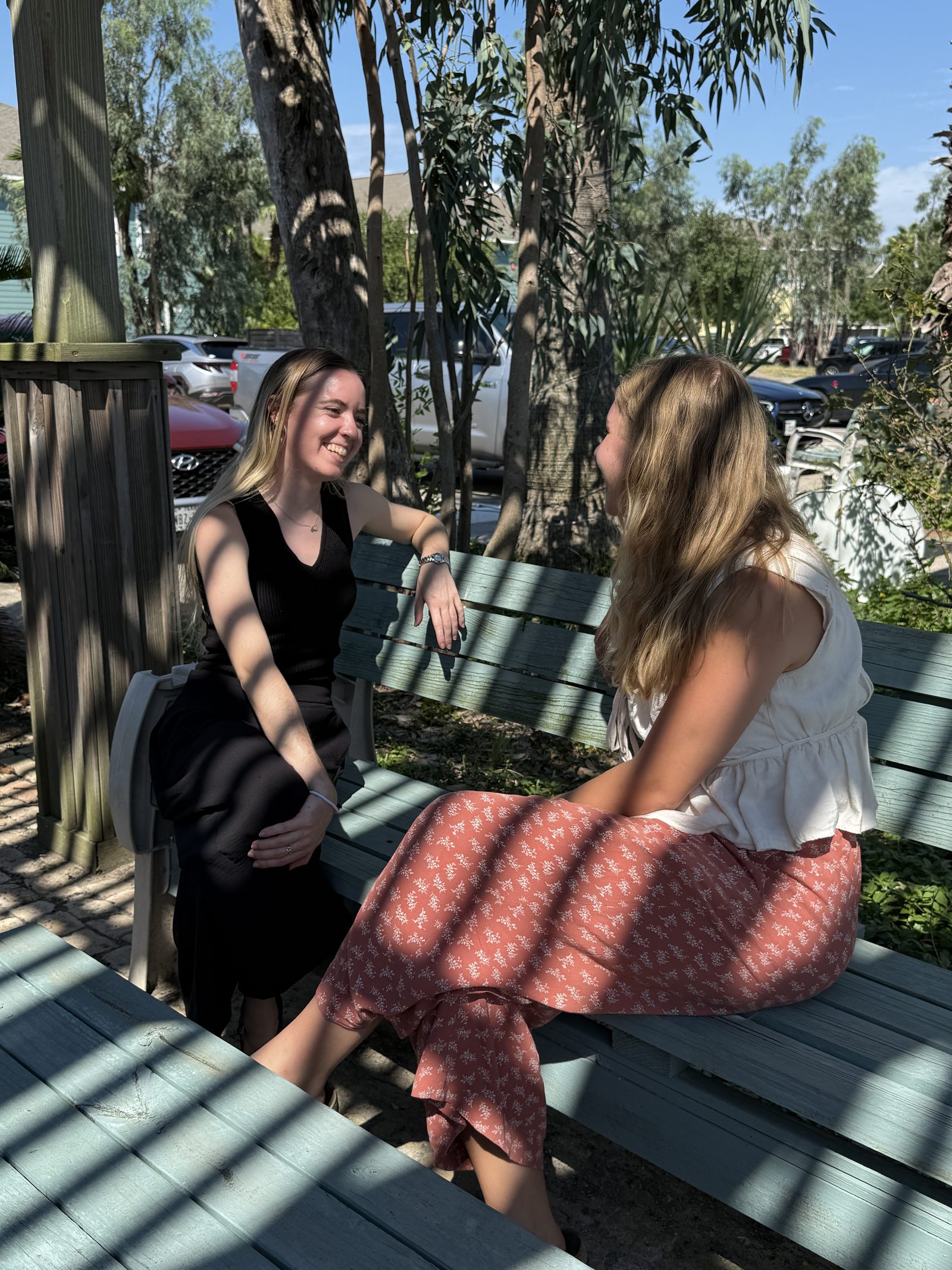 Two residents talking on an outdoor UAG patio